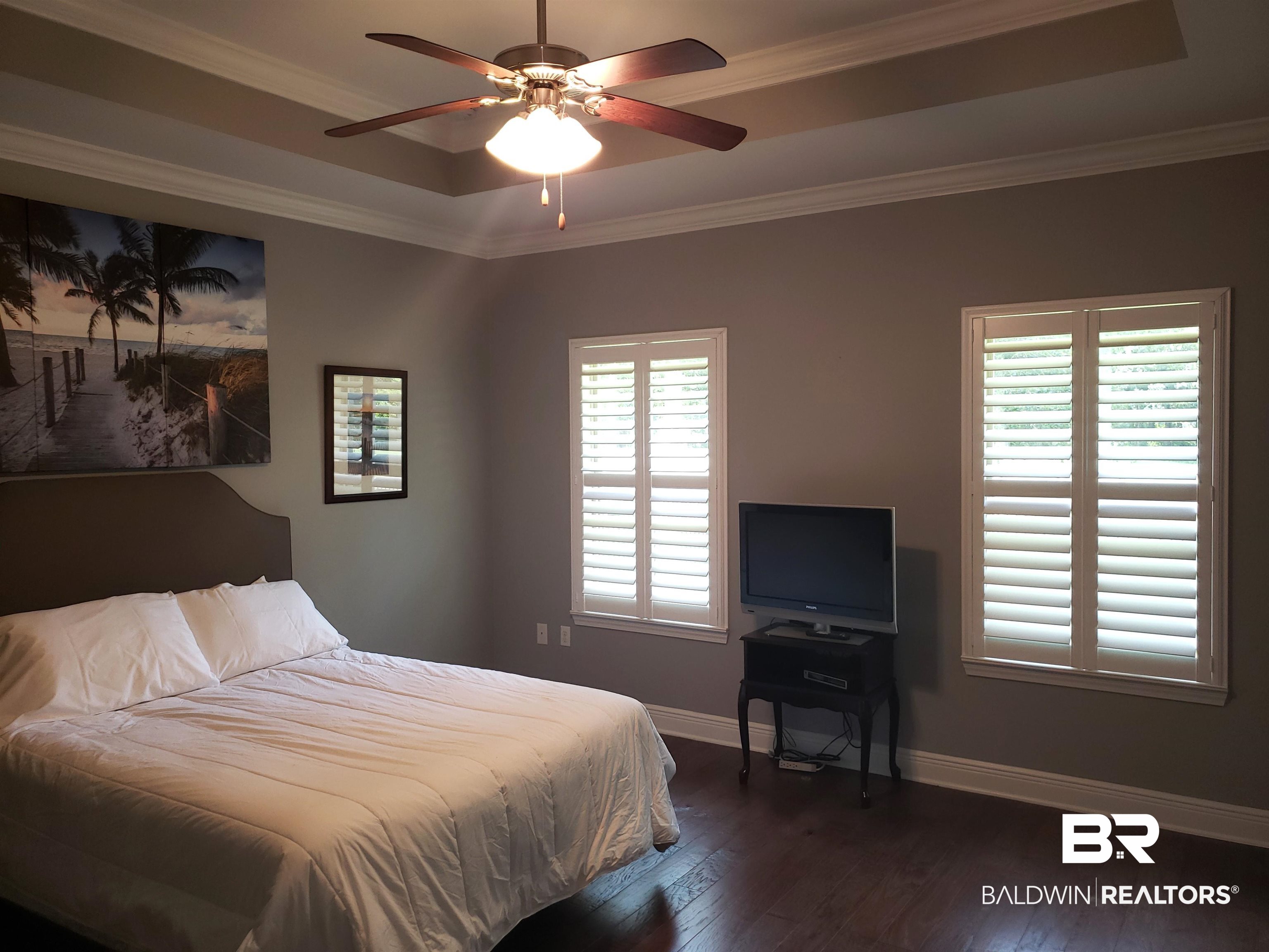 23373 Dundee Circle Foley, AL 36535 - Photo 12 of 34 Bedroom with ceiling fan, hardwood / wood-style flooring, crown molding, and a tray ceiling