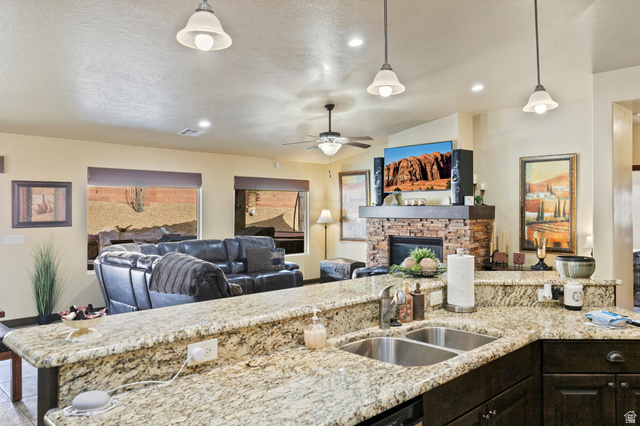 210 Talon Court Ivins, UT 84738 - Photo 60 of 60 Kitchen with light stone countertops, open floor plan, and lofted ceiling