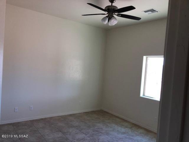 1412 Via Merida Rio Rico, AZ 85648 - Photo 6 of 7 an empty room with a window and a fan