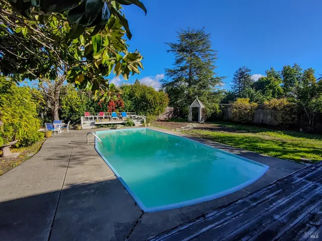 a view of a swimming pool with an outdoor space and seating area