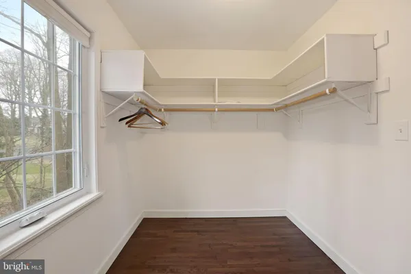 a view of a room with rack on the wall and a window