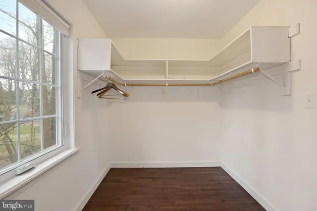 a view of a room with rack on the wall and a window