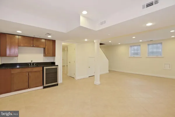 a large kitchen with stainless steel appliances granite countertop a stove a sink and a refrigerator