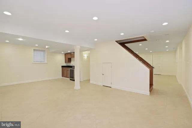 a view of an empty room with a kitchen
