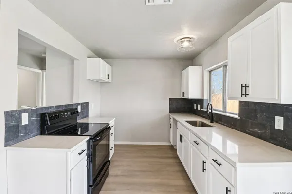 a kitchen with a stove and a refrigerator