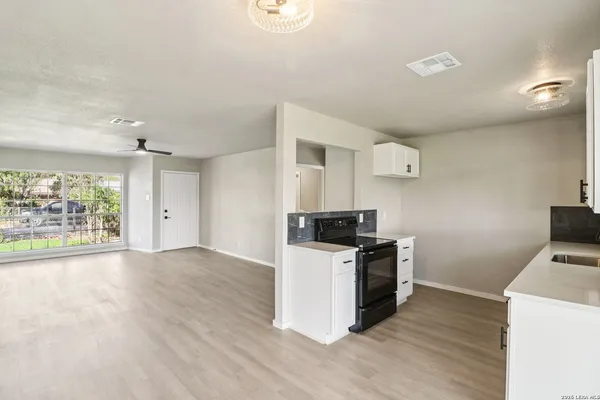 a kitchen with a stove and a refrigerator