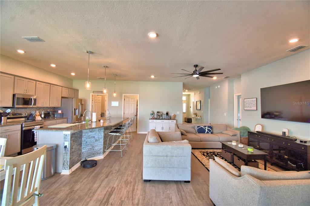 4340 Reding Way Lakeland, FL 33813 - Photo 16 of 63 a living room with stainless steel appliances furniture and a flat screen tv