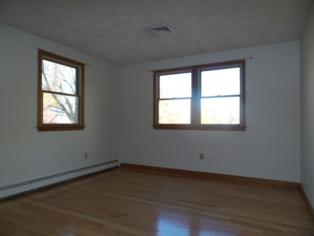 114 Avalon Road Reading, MA 01867 - Photo 13 of 29 a view of wooden floor and windows in a room