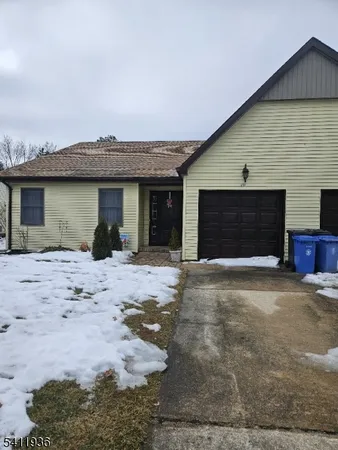 a view of a house with a yard and garage