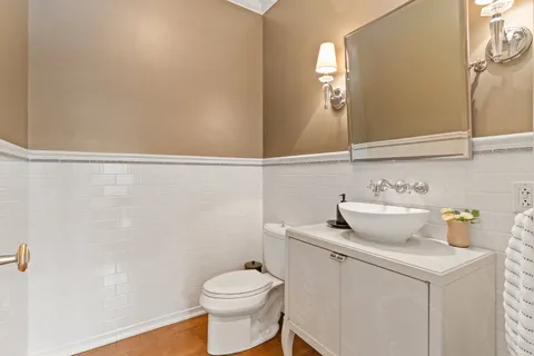 a bathroom with a sink a toilet and mirror