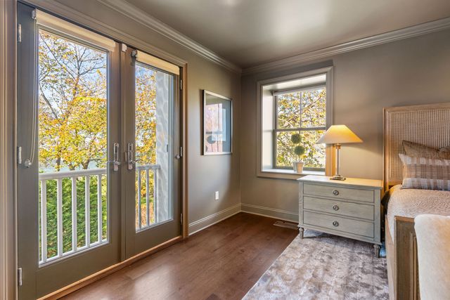a view of a bedroom with wooden floor and a window