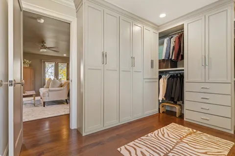 a view of a bedroom with a furniture and wooden floor