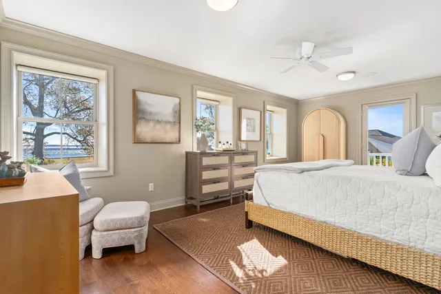 a spacious bedroom with a bed window and couch