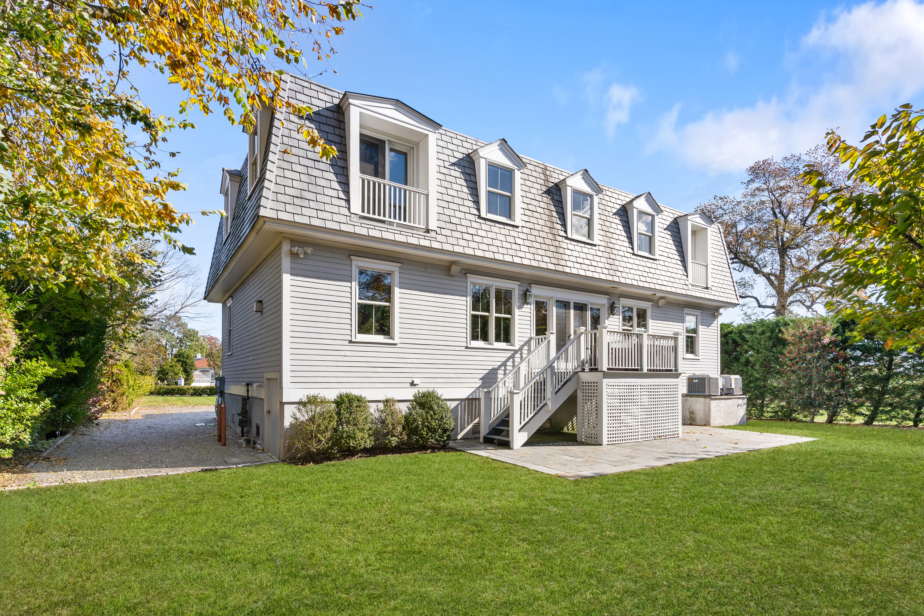 75 Saddle Rock Road Stamford, CT 06902 - Photo 34 of 40 a front view of a house with a yard and trees