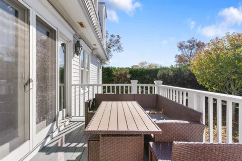 a view of balcony with wooden floor and fence