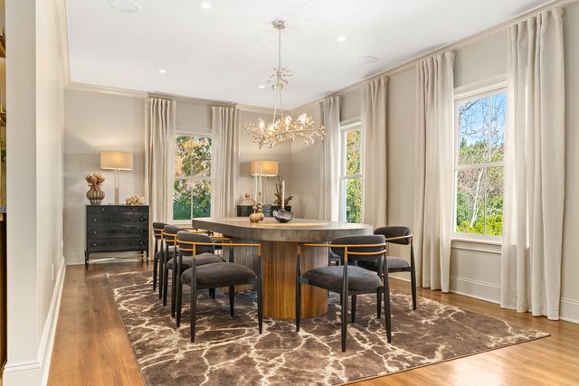 a view of a a dining room with furniture window and wooden floor