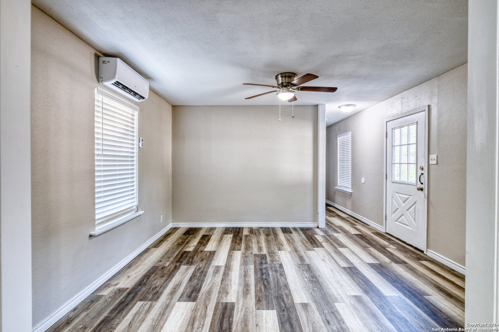 640 Roach Street Uvalde, TX 78801 - Photo 1 of 23 wooden floor in an empty room with a window