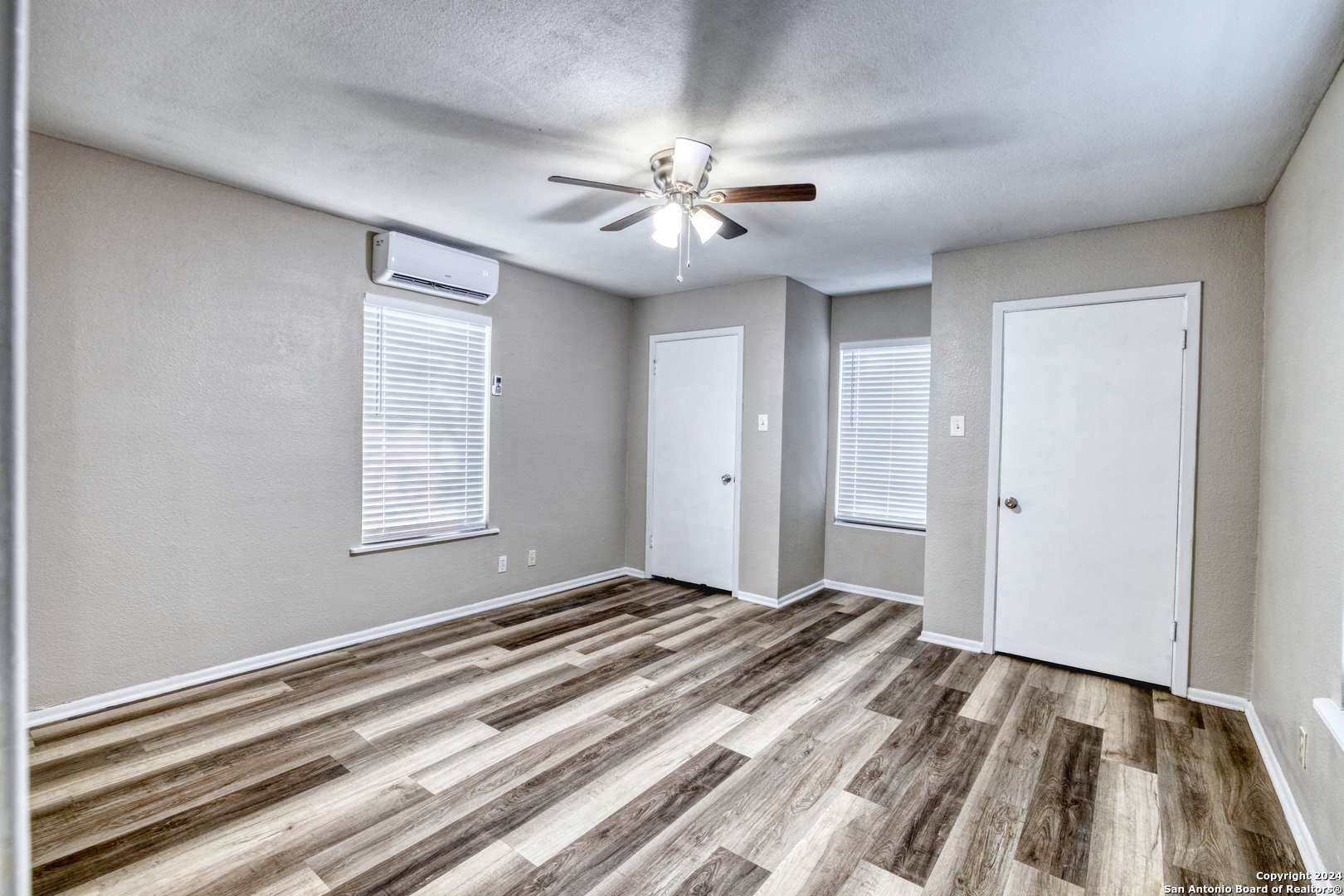 640 Roach Street Uvalde, TX 78801 - Photo 13 of 23 a view of an empty room with window and chandelier fan