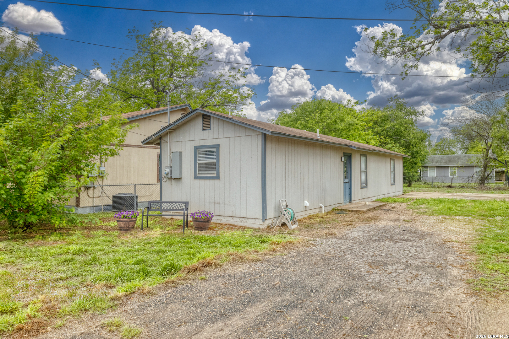 640 Roach Street Uvalde, TX 78801 - Photo 3 of 23 a backyard of a house with table and chairs and wooden fence