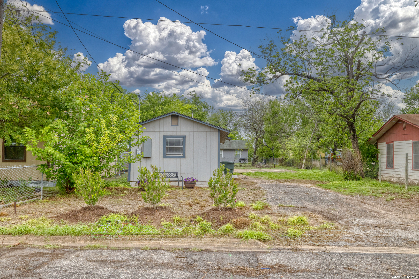 640 Roach Street Uvalde, TX 78801 - Photo 4 of 23 a view of a yard in front of a house with large trees