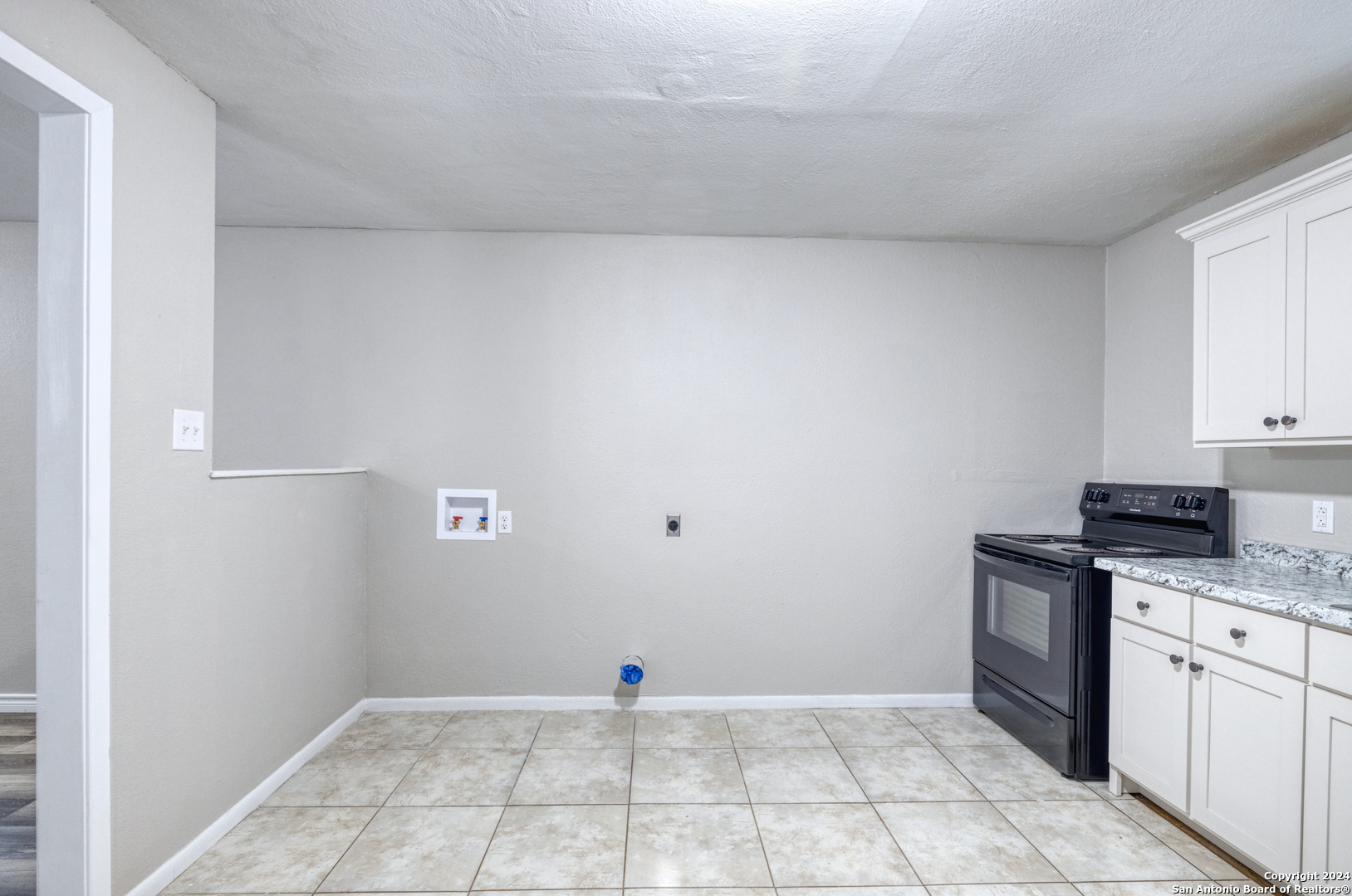 640 Roach Street Uvalde, TX 78801 - Photo 9 of 23 a view of a kitchen with white cabinets