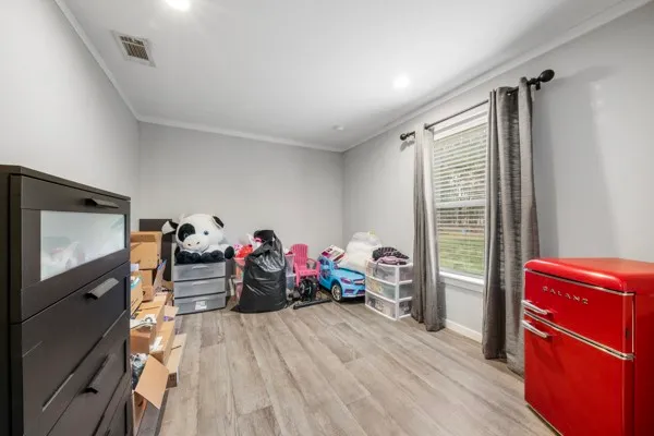a view of a livingroom with furniture window and hardwood floor
