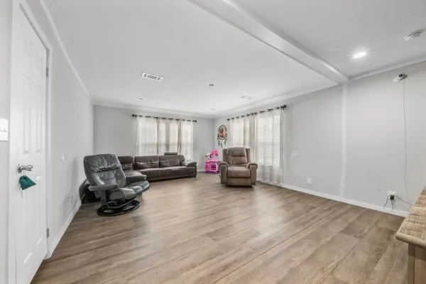 a view of a livingroom with furniture and a window