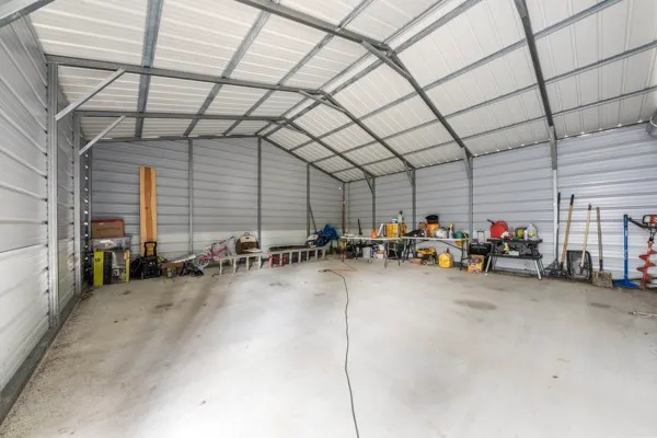 a view of a garage with a bike and white car