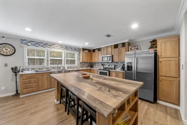 a kitchen with a table chairs sink and refrigerator