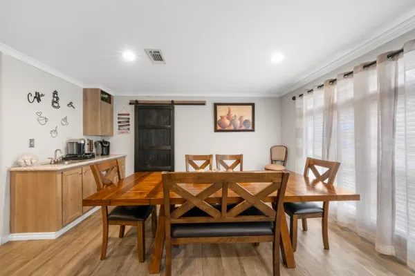 a view of a dining room with furniture and wooden floor