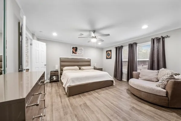 a bedroom with a large bed couch and a window