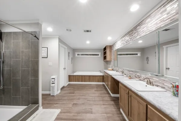 a large bathroom with a sink and a large mirror