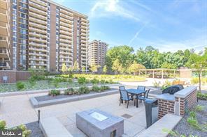 1800 Old Meadow Road, Unit 101 McLean, VA 22102 - Photo 15 of 50 a view of swimming pool with outdoor seating and plants