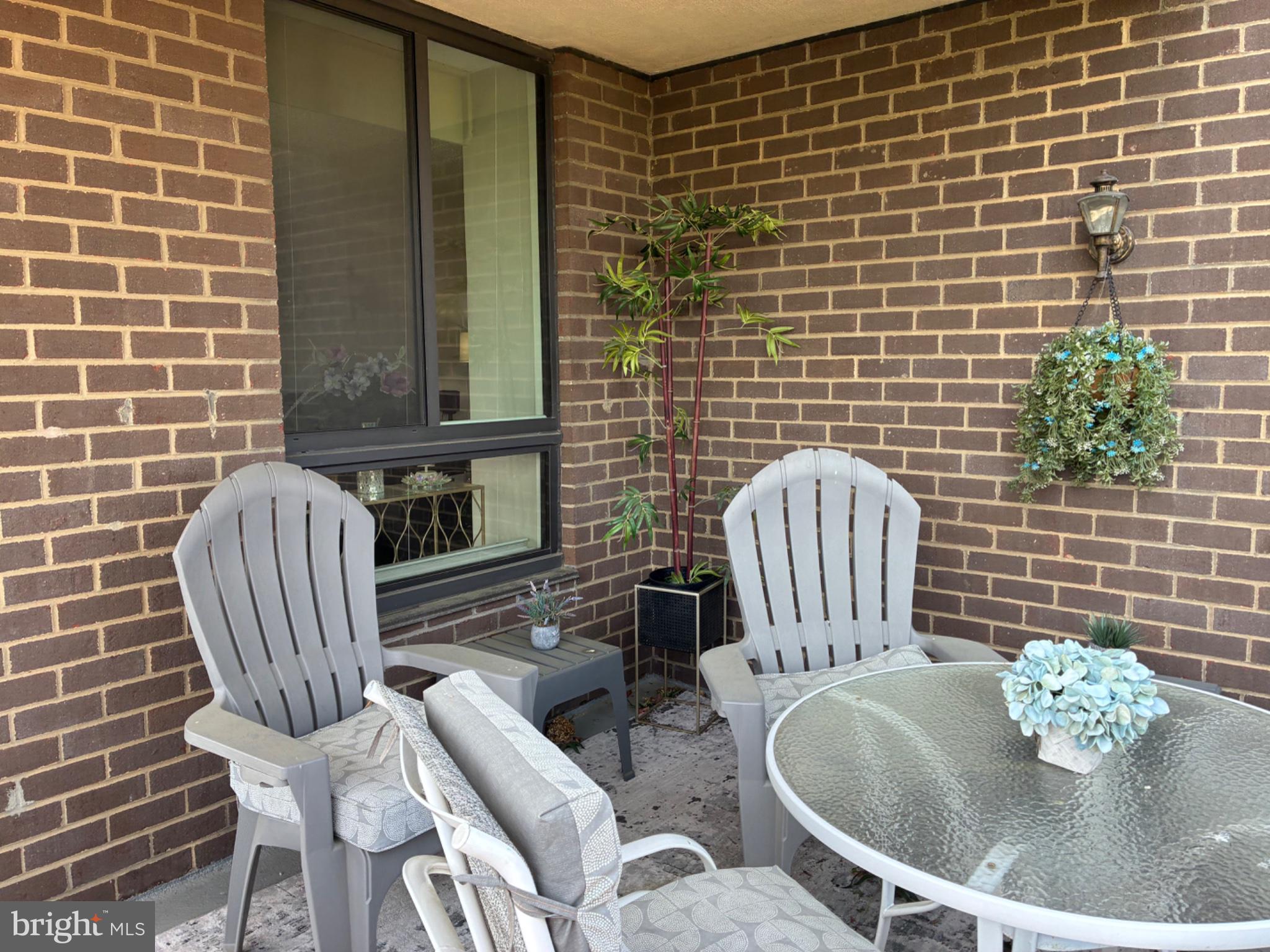 1800 Old Meadow Road, Unit 101 McLean, VA 22102 - Photo 21 of 50 a view of a patio with chair and table