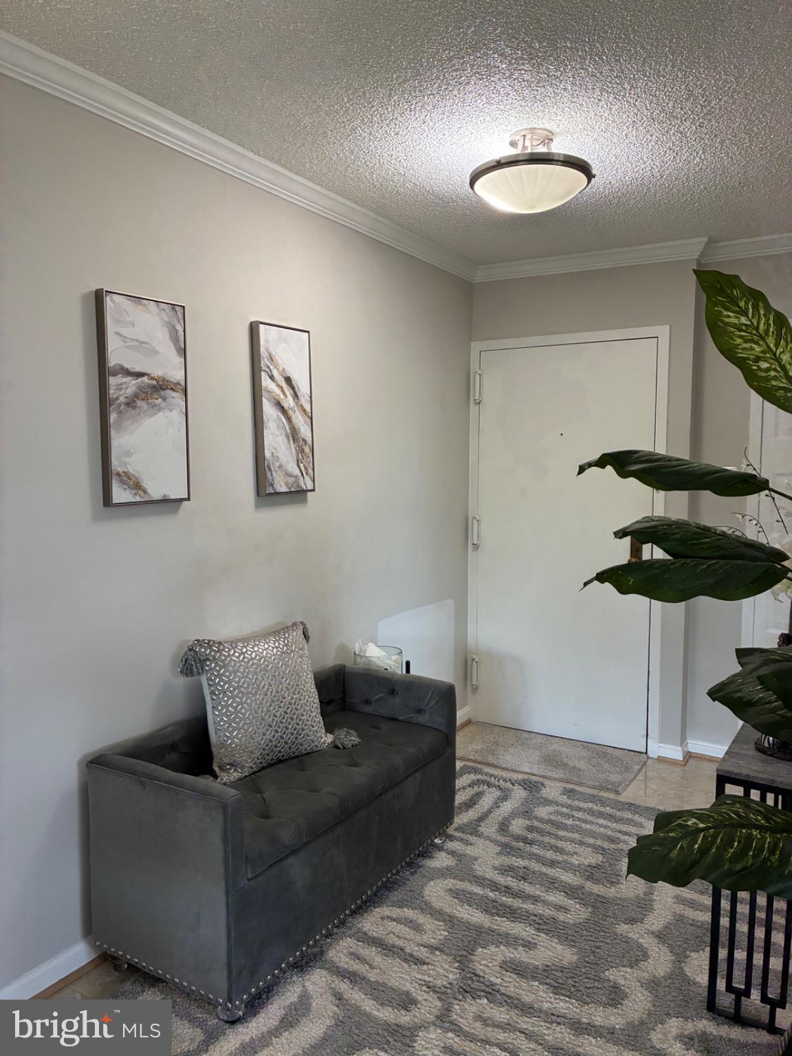 1800 Old Meadow Road, Unit 101 McLean, VA 22102 - Photo 27 of 50 a living room with furniture and a lamp