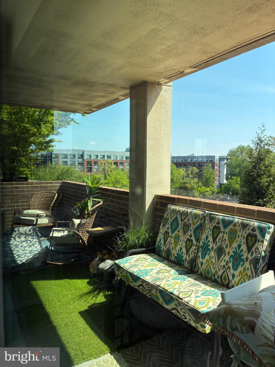 1800 Old Meadow Road, Unit 101 McLean, VA 22102 - Photo 34 of 50 a balcony with furniture and a garden