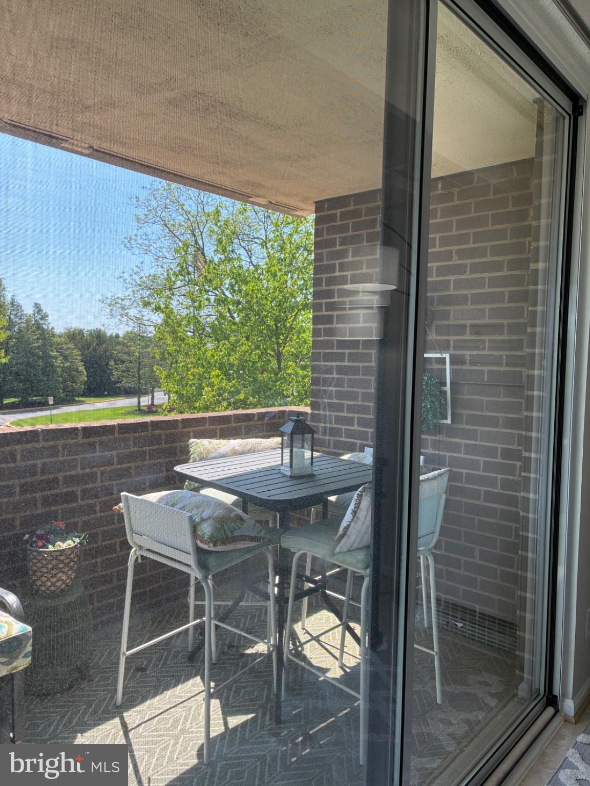 1800 Old Meadow Road, Unit 101 McLean, VA 22102 - Photo 35 of 50 a balcony with table and chairs