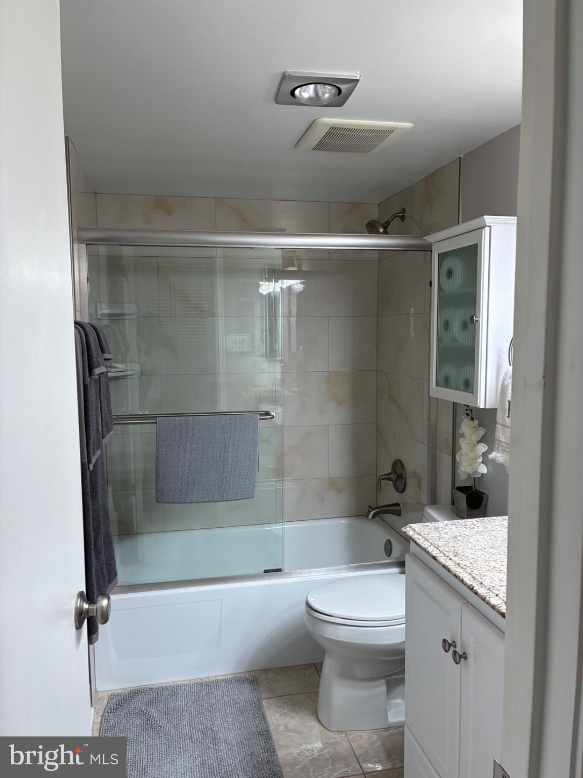 1800 Old Meadow Road, Unit 101 McLean, VA 22102 - Photo 43 of 50 a bathroom with a sink a toilet and shower