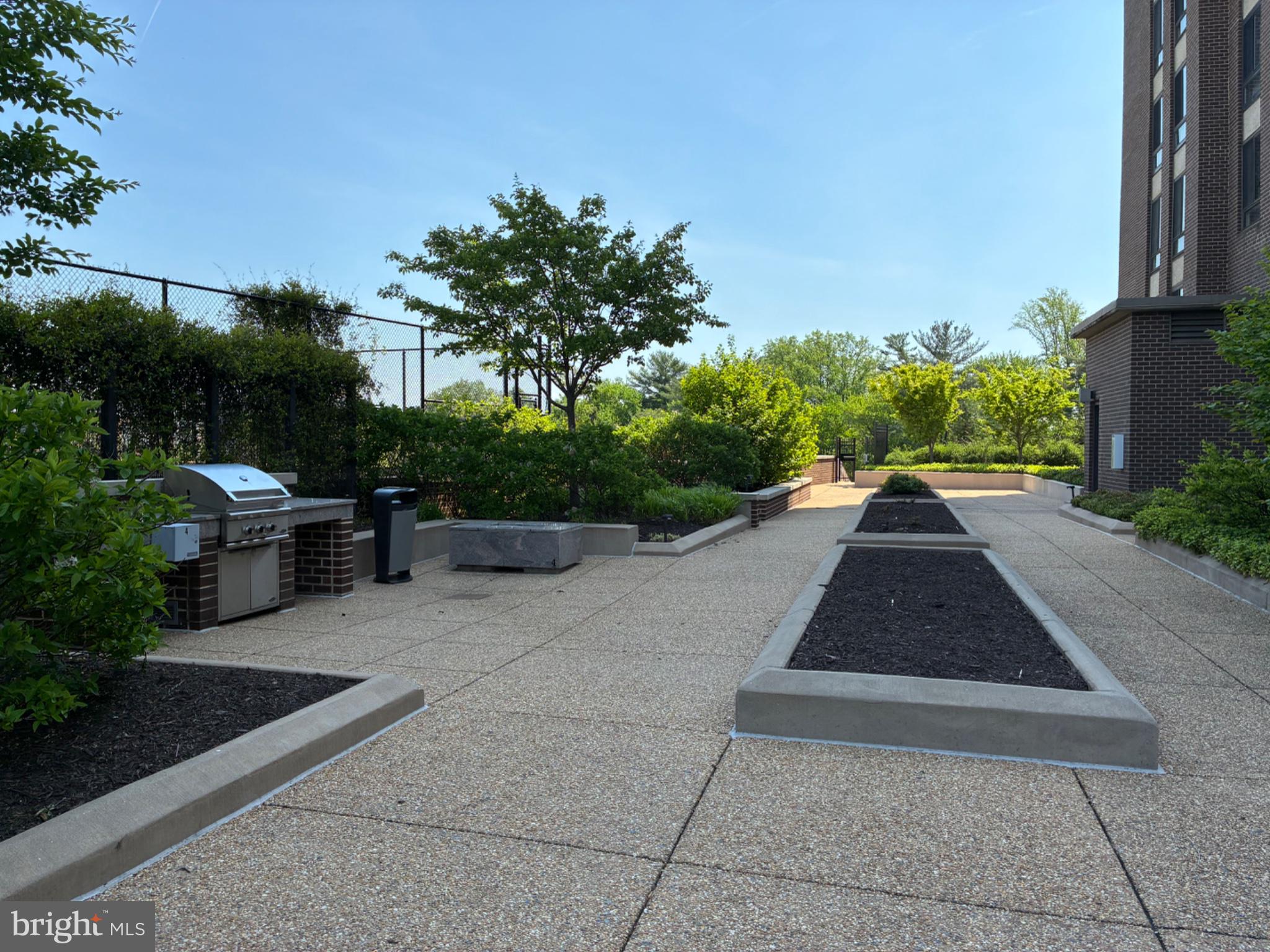 1800 Old Meadow Road, Unit 101 McLean, VA 22102 - Photo 8 of 50 a view of a yard with plants and a bench
