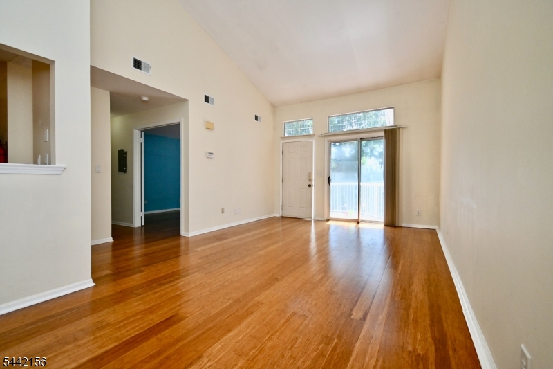 4 Cedar Court Bedminster, NJ 07921 - Photo 3 of 16 a view of an empty room with wooden floor and a window
