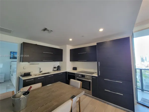 a kitchen with a stove and a refrigerator