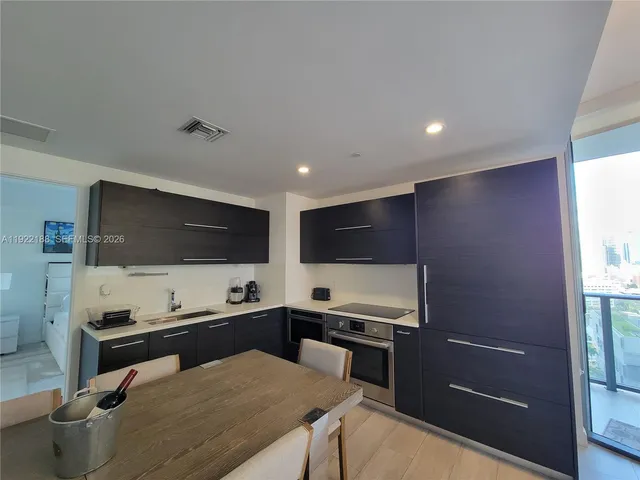 a kitchen with a stove and a refrigerator