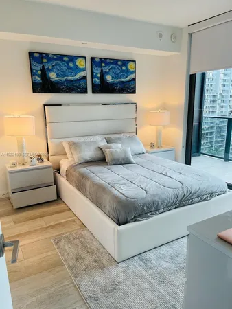 a bedroom with a large bed and a dresser