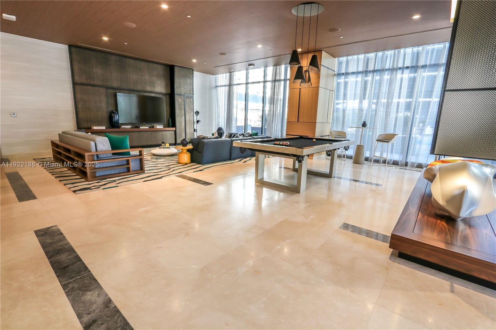 45 Southwest 9th Street, Unit 2201 Miami, FL 33130 - Photo 18 of 28 a living room with furniture and a flat screen tv