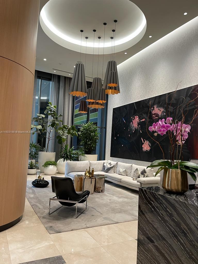 45 Southwest 9th Street, Unit 2201 Miami, FL 33130 - Photo 28 of 28 a living room with furniture and a flat screen tv