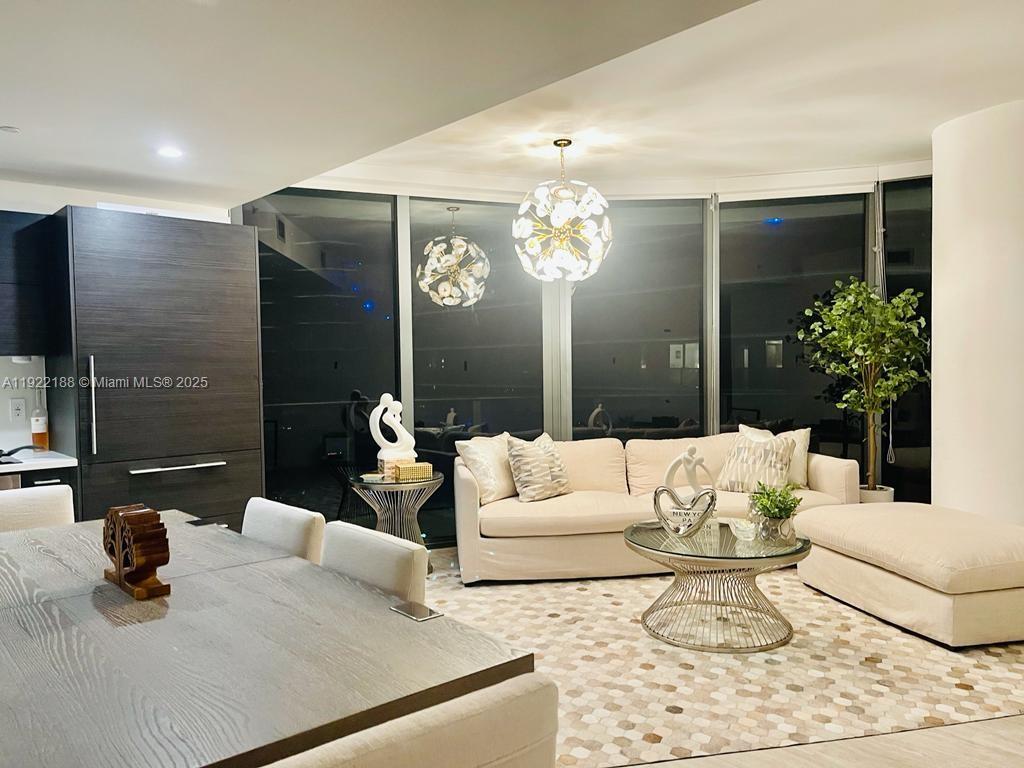 45 Southwest 9th Street, Unit 2201 Miami, FL 33130 - Photo 3 of 28 a living room with furniture and a chandelier
