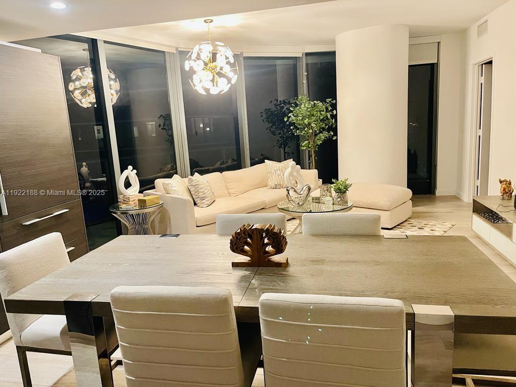 45 Southwest 9th Street, Unit 2201 Miami, FL 33130 - Photo 4 of 28 a living room with furniture and a chandelier