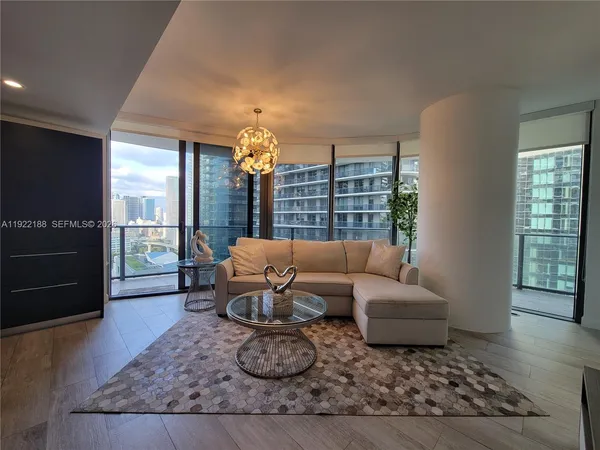 a living room with furniture rug and window
