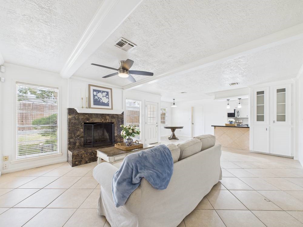 8315 Lichen Lane Spring, TX 77379 - Photo 1 of 31 a living room with furniture a fireplace and a flat screen tv