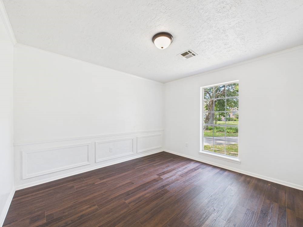 8315 Lichen Lane Spring, TX 77379 - Photo 11 of 31 an empty room with wooden floor and windows